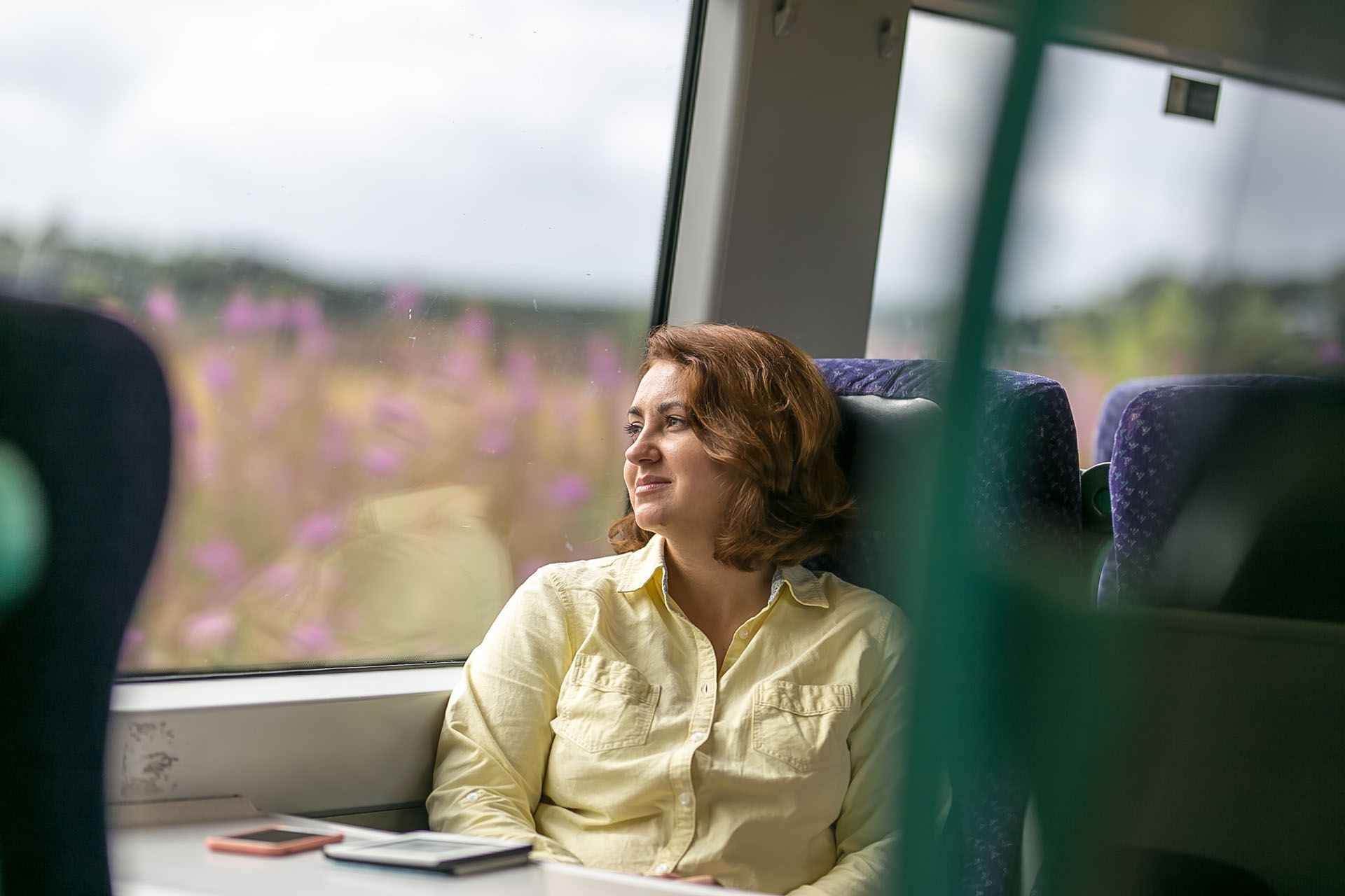 A woman looking out of the window of a train 