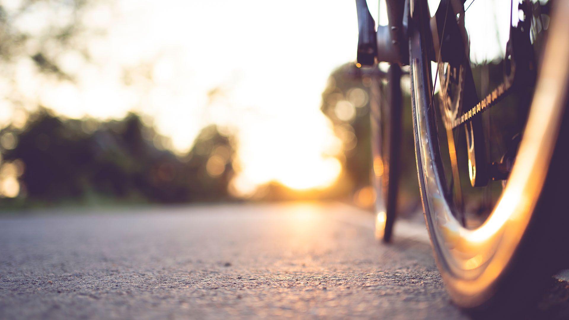 close up of a bike tyre riding on a cycle path